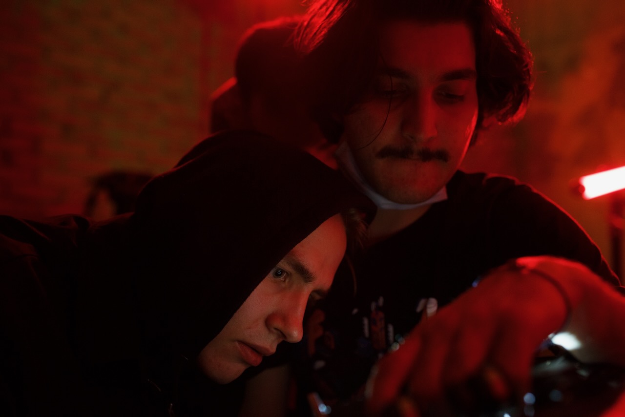 Two crew members watching a playback screen.