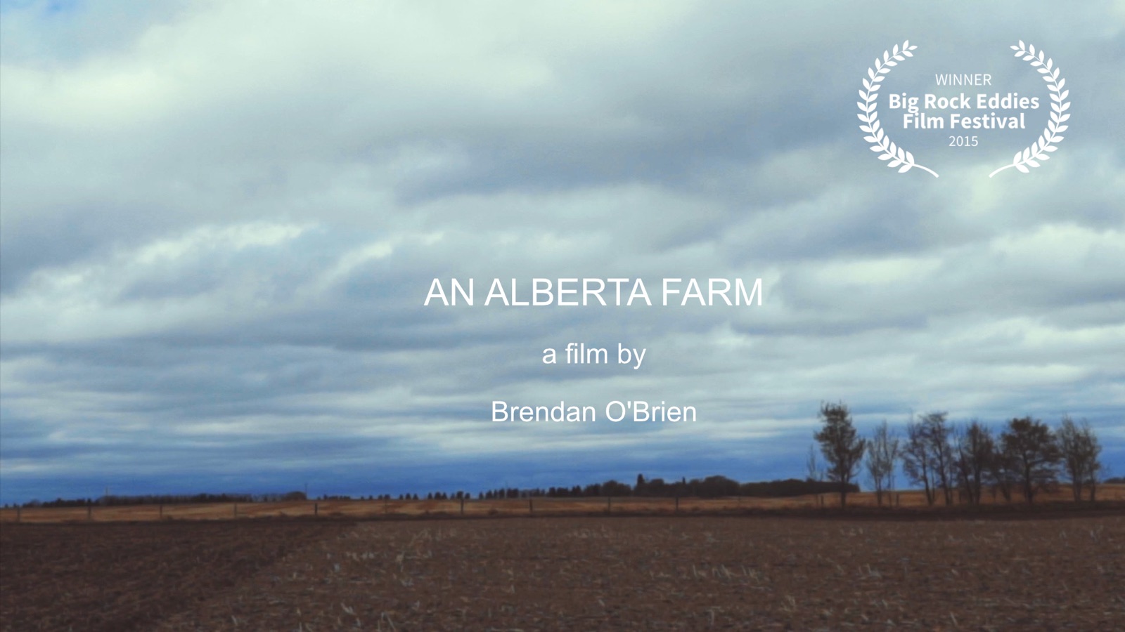 A ploughed Alberta field under a heavy sky.