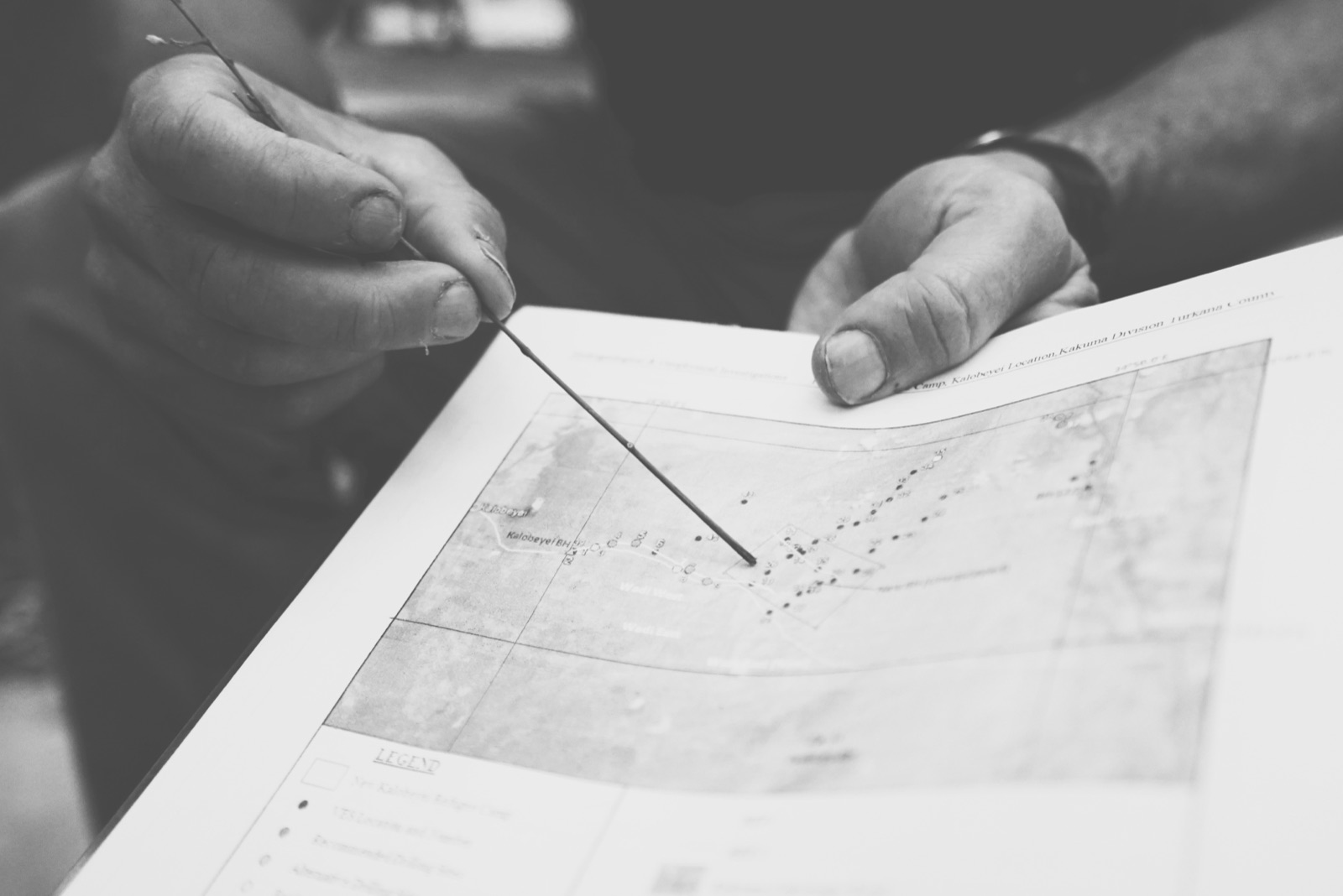 Hands pointing to a map of Kakuma Division, Turkana County.