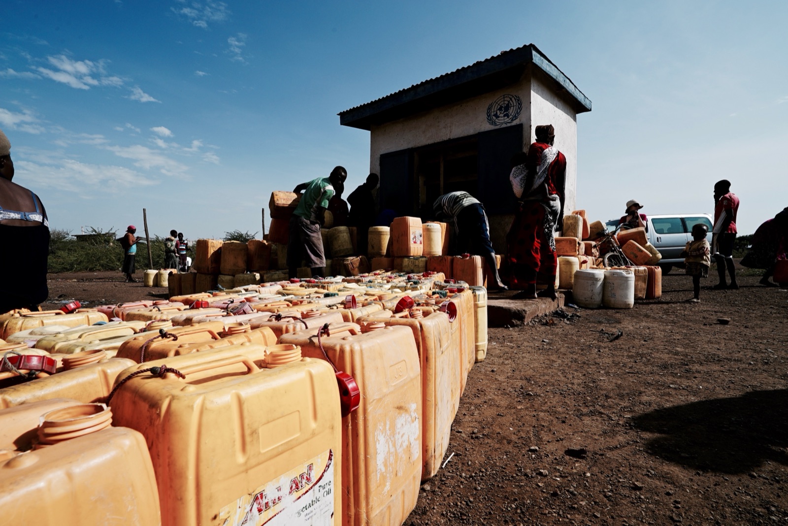 Rows of yellow jerry cans at a UN water point.