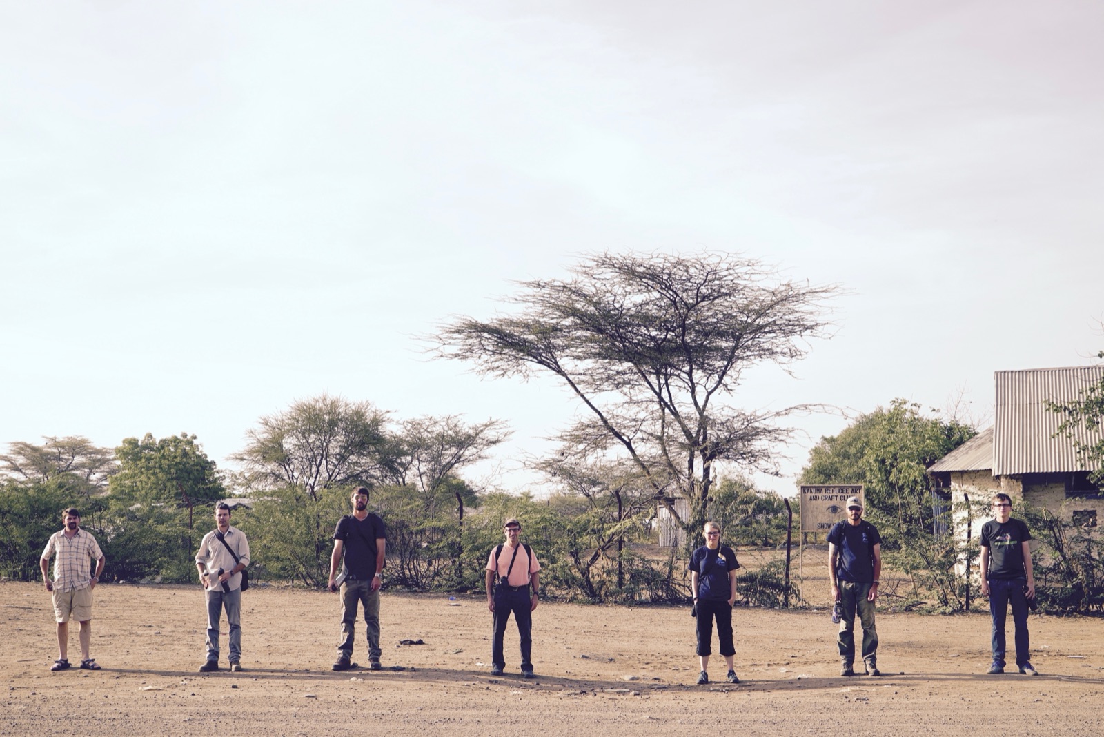 The Finding Water crew standing in a line on dusty ground.